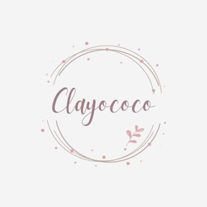 May include: A logo design featuring the word "Clayococo" in a cursive font, enclosed within a circular frame. The design incorporates a soft color palette of pink and beige, with small dots and a leaf accent.