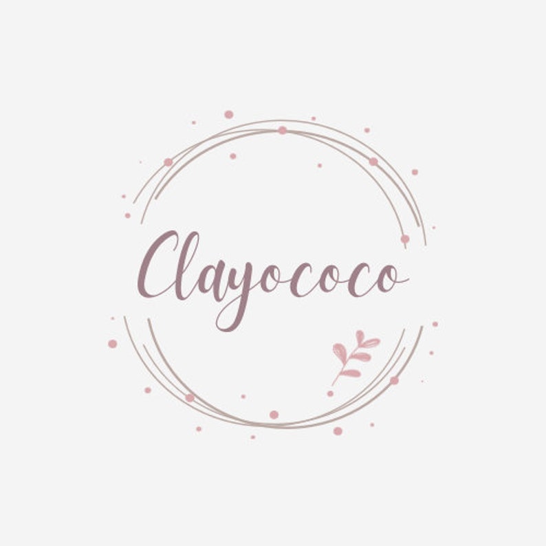 May include: A logo design featuring the word "Clayococo" in a cursive font, enclosed within a circular frame. The design incorporates a soft color palette of pink and beige, with small dots and a leaf accent.
