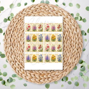 May include: A sheet of floral art prints showcasing a variety of colourful flowers, including red, purple, yellow, and blue blooms. The prints are arranged in a grid pattern on a white background, with a vintage aesthetic. The image is set on a woven mat.