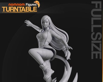 May include: A gray 3D printed figurine of a female character with long hair standing on a base with a flame design. The figurine is posed with one leg raised and an arm outstretched. The base is circular with a raised edge and a textured surface.