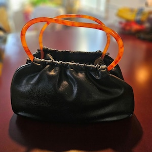 Amazing Vintage Bag...totally usable and right in style!  Butterscotch Handles and little feet, too! ;)
