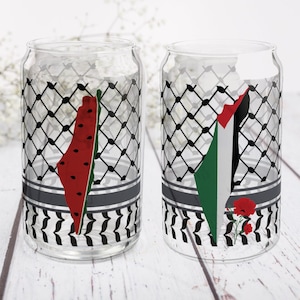 May include: Two clear glass tumblers with black and white patterned designs. One tumbler features a watermelon-shaped outline of Israel, the other features a Palestinian flag with red poppies.