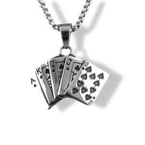 May include: Silver-toned pendant necklace featuring a poker hand of playing cards: Ace, Queen, Jack, and 10 of spades. The pendant is suspended from a chain. The cards are fanned out, showcasing the details of the card faces.