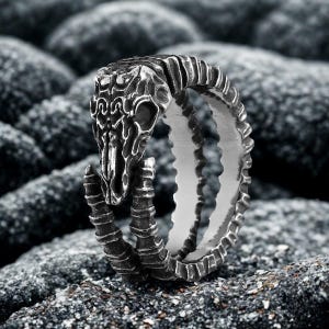 May include: A set of three ceramic mugs with a speckled, matte finish. The mugs are in shades of cream, light gray, and dark gray. Each mug has a simple, minimalist design, perfect for coffee or tea.