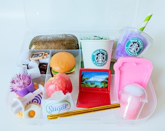 May include: A clear plastic storage case filled with various pretend food and drink items, including a burger, apple, sugar packet, donuts, a laptop, and two coffee cups with the logo "Busy Hands & Learning".