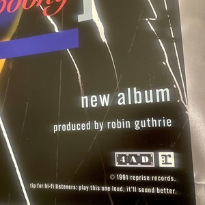 Pode incluir: Um cartaz preto e branco com o texto "booky new album produced by robin guthrie 4AD 1991 reprise records. tip for hi-fi listeners: play this one loud, it'll sound better."