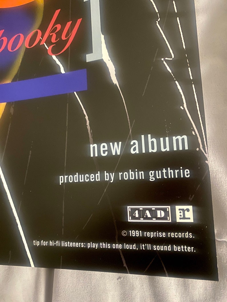Pode incluir: Um cartaz preto e branco com o texto "booky new album produced by robin guthrie 4AD 1991 reprise records. tip for hi-fi listeners: play this one loud, it'll sound better."