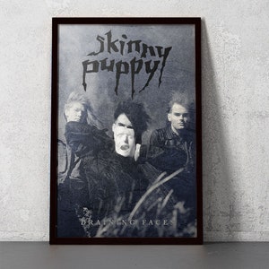 May include: A black and white poster with the band Skinny Puppy's name in a gothic font. The band members are pictured in the poster, with the text "Draining Faces" at the bottom.