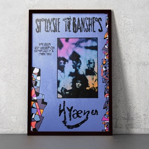 May include: A framed poster advertising the band Siouxsie and the Banshees' album "Hyæna". The poster features a black and white photo of the band members against a purple and pink background. The text "NEW ALBUM ALSO AVAILABLE ON CHROME CASSETTE & COMPACT DISC" is printed in white on a blue background.