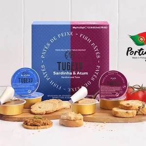 May include: A box of two 80 gram (4 x 22 gram) tubs of Portuguese fish pate. The box is blue and red and says "TUGEXP Sardinha & Atum Sardine and Tuna" on the front. The tubs are labeled "TUGEXP" and are filled with pate. The image also shows a rooster figurine, tomatoes, and crackers.