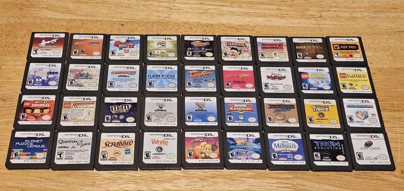May include: A collection of 30 Nintendo DS game cartridges, including titles such as "Flash Focus", "M&M's", "Scribble", and "Tron Evolution".