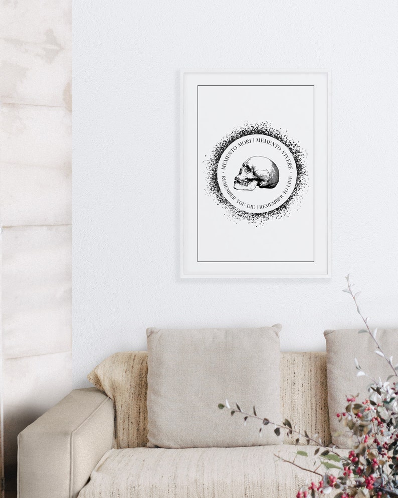 May include: Black and white print of a skull with the text "Memento Mori | Memento Vivere | Remember You Die | Remember to Live" in a circle around it.