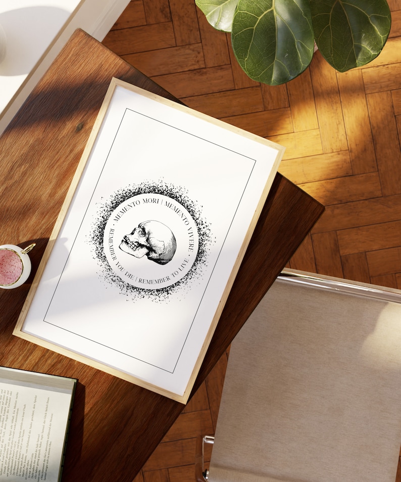 May include: Black and white print of a skull with the text "Memento Mori | Memento Vivere - Remember You Die | Remember To Live" in a circle around it.