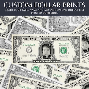 以下が含まれることがあります： 肖像画の部分に子供の顔が印刷された、カスタム印刷された1ドル札。札には「Happy 1st Birthday」という文字が印刷されています。札は他の1ドル札に囲まれています。