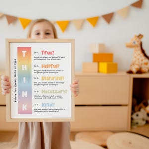 May include: A framed poster with the word "THINK" in large, colorful letters. The poster lists questions to consider before speaking, writing, or typing, such as "Is it True?" and "Is it Kind?" The frame is light-colored wood.