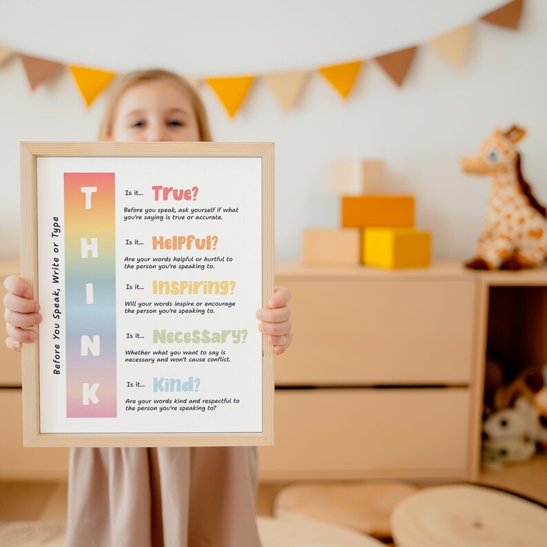 May include: A framed poster with the word "THINK" in large, colorful letters. The poster lists questions to consider before speaking, writing, or typing, such as "Is it True?" and "Is it Kind?" The frame is light-colored wood.