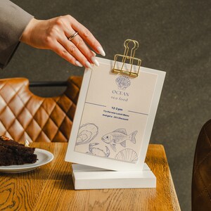Custom plywood menu holder designed for cocktail menus at bars, personalized with your logo or message for a polished table setup.