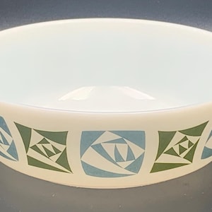 May include: White ceramic baking dish with a geometric pattern in shades of blue and green. The pattern features squares with abstract designs.
