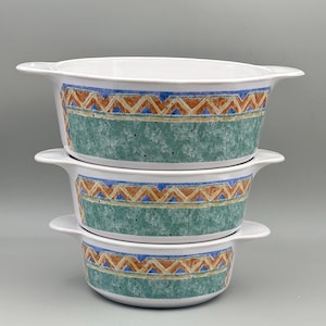 May include: Three white ceramic bowls stacked on top of each other. Each bowl has a green speckled band with a geometric pattern in orange, blue, and yellow. The bowls have handles on either side.