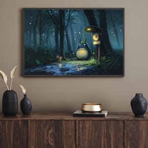May include: Framed art print featuring a whimsical forest scene with a large, round, dark blue creature with a white belly. The artwork depicts a path, trees, and glowing lights, creating a magical atmosphere. The print is displayed above a wooden cabinet.