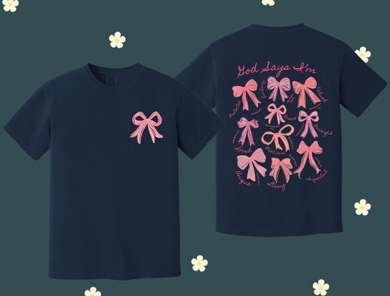 May include: Two navy blue t-shirts with pink bows and the text "God says I'm" with a list of positive words. The words include: loved, unique, precious, strong, gifted, valued, thoughtful, and supported.