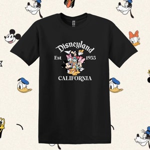May include: Black t-shirt with a white graphic of Mickey Mouse, Minnie Mouse, Donald Duck, Goofy, and Pluto. The graphic says "Disneyland Est 1955 California".