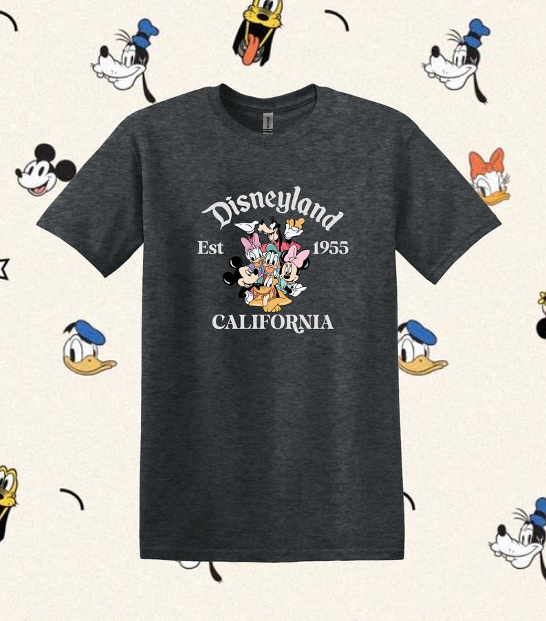 May include: A dark heather grey t-shirt with a white graphic of Mickey Mouse, Minnie Mouse, Donald Duck, Goofy, Pluto, and Daisy Duck. The graphic includes the text "Disneyland Est 1955 California".