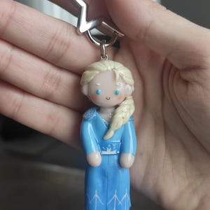 May include: A white ceramic mug with a black handle and the text "But First, Coffee" in a handwritten style. The mug is on a white surface. The mug is 4 inches tall.