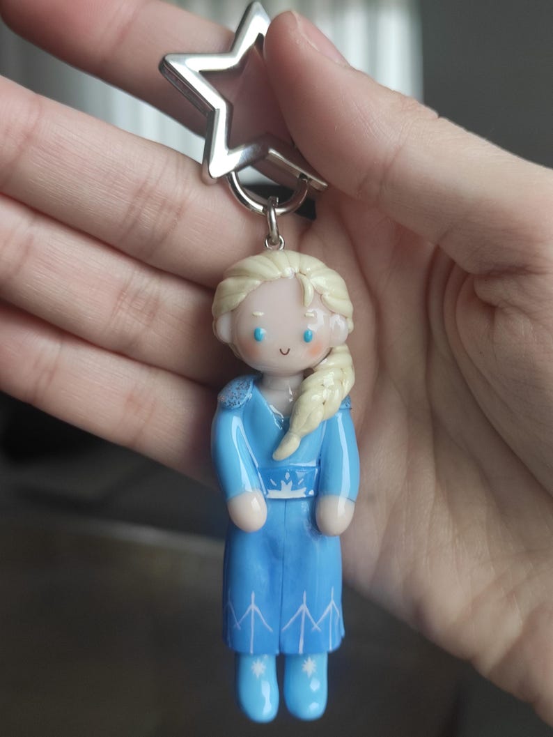 May include: A white ceramic mug with a black handle and the text "But First, Coffee" in a handwritten style. The mug is on a white surface. The mug is 4 inches tall.