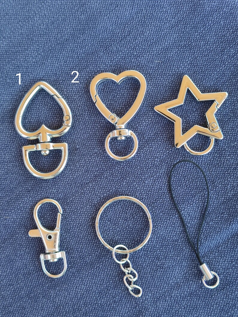 May include: A white ceramic mug with a black handle and the text "But First, Coffee" in a black, bold font. The mug is on a white surface. The mug is approximately 4 inches tall.