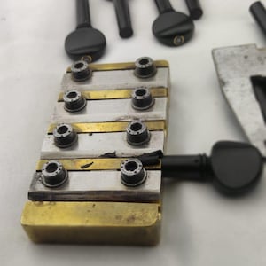 Mother-of-pearl tuning pegs for the Turkish bağlama, an instrument made of ebony wood.