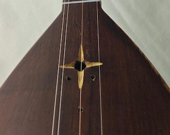 Custom-made, handcrafted *kopuz* (lute) with a carved, one-piece body. Traditional Turkish stringed instrument.