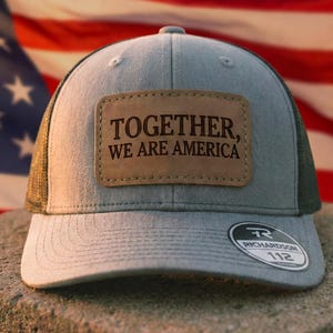 May include: A white ceramic mug with a black handle and the text "But first, coffee" in a black, handwritten-style font. The mug is on a white surface.