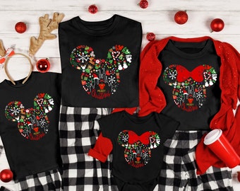 May include: A family matching Christmas pajama set with black and white plaid pants and black short-sleeved shirts featuring a Mickey Mouse design with a red bow and the text "Merry Christmas".