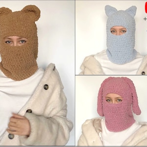 May include: Three different styles of crocheted balaclavas with ear flaps. The first is brown with bear ears, the second is light blue with cat ears, and the third is pink with bunny ears.