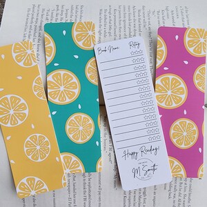 May include: Three colorful bookmarks with a lemon pattern. The bookmarks are teal, yellow, and pink. The bookmark in the center has a white section with the text "Happy Reading!" and "M Smith Creations".