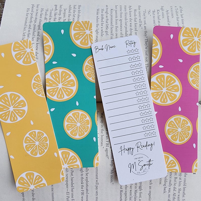 May include: Three colorful bookmarks with a lemon pattern. The bookmarks are teal, yellow, and pink. The bookmark in the center has a white section with the text "Happy Reading!" and "M Smith Creations".