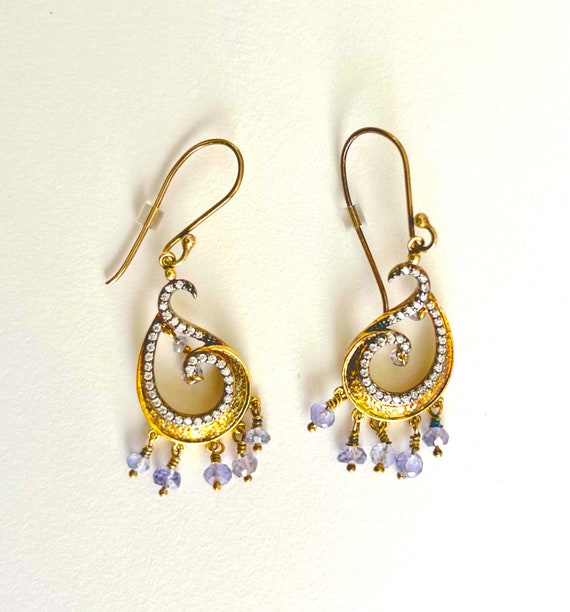 Gold dangling earrings with lavender beads.
