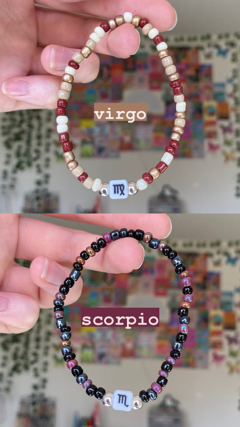 May include: Two beaded bracelets, one with burgundy, cream, and gold beads, the other with black, purple, and bronze beads. The first bracelet has a white square bead with the word "virgo" and a Virgo symbol. The second bracelet has a white square bead with the word "scorpio" and a Scorpio symbol.