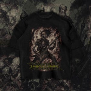 May include: Black t-shirt featuring a skeletal figure playing a guitar, with a fiery background. The design includes the text "THE ABYSS" in green. The shirt has a vintage, distressed look, with a crew neck and short sleeves.