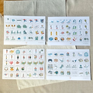 May include: Four white sheets of paper with colorful illustrations of various activities and objects. The illustrations are organized in a grid format with each square containing a different image. The images include activities like swimming, playing, eating, and sleeping, as well as objects like a toothbrush, a car, a book, and a phone. The sheets are labeled with German words.