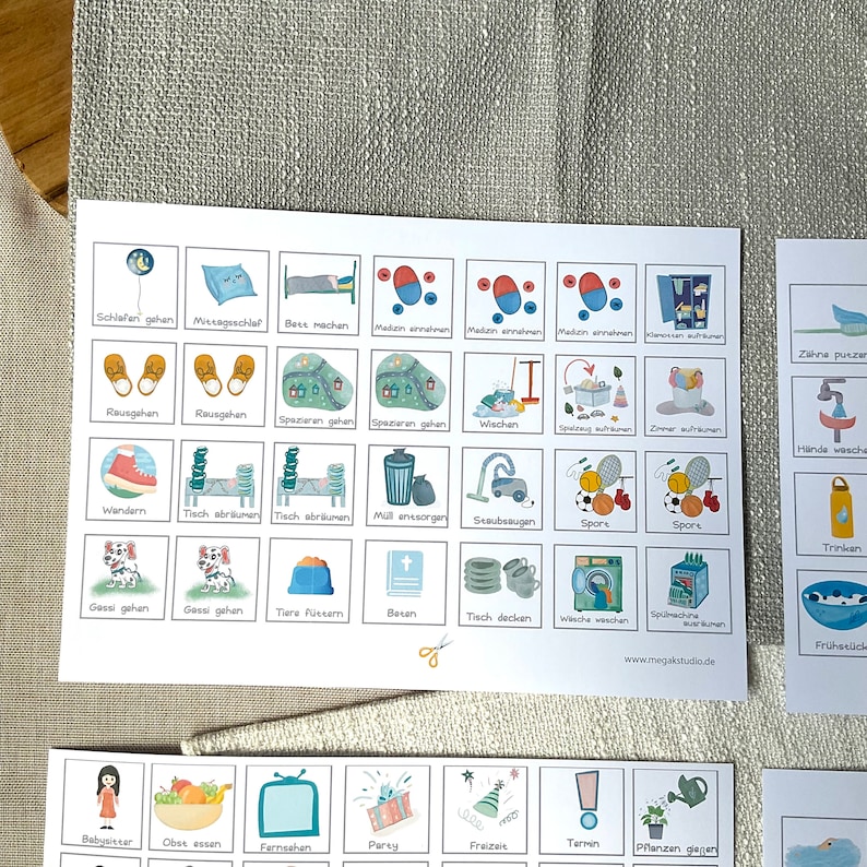 May include: A colorful chart with illustrated icons and German text describing daily activities. The chart includes activities like sleeping, eating, playing, cleaning, and more.