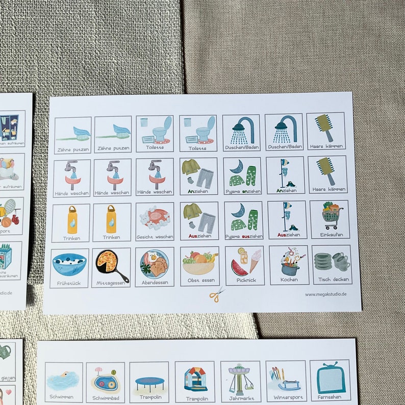 May include: A set of 36 illustrated cards featuring various daily activities, such as brushing teeth, getting dressed, eating, and playing. The cards are printed on white paper with a light blue border and feature colorful illustrations.