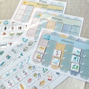 May include: A set of three colorful charts with checkboxes and illustrations for a child's daily routine. The charts are labeled "Morgens", "Mittags", and "Abends" and include activities like brushing teeth, getting dressed, and eating breakfast.