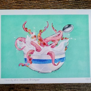 May include: A pink octopus with colorful cereal in its tentacles is submerged in a bowl of milk with a spoon sticking out. The bowl has a blue and white striped design. The background is a light turquoise color. The text "Part of This Complete Breakfast!" is at the bottom of the image.