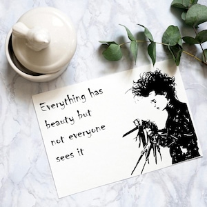May include: Black and white print of a character from the movie Edward Scissorhands. The quote "Everything has beauty but not everyone sees it" is printed on the white background.