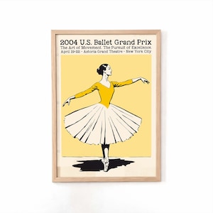 May include: A framed poster for the 2004 U.S. Ballet Grand Prix. The poster features a ballerina in a yellow leotard and white tutu, set against a yellow background. Text at the top reads "2004 U.S. Ballet Grand Prix".