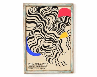 May include: A framed vintage poster for the Philadelphia Jazz Festival, June 15-17, 1964. The artwork features black and white wavy lines, with red, yellow, and blue geometric shapes. The frame is a distressed light blue.