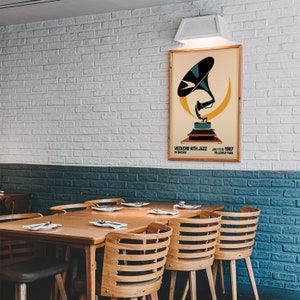May include: A vintage poster advertising a "Weekend with Jazz" event in Chicago on July 11-12, 1987 at Millennium Park. The poster features a stylized illustration of a gramophone with a yellow background.