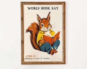 May include: A framed poster featuring a brown squirrel wearing a yellow shirt and blue pants, reading an orange book. The text reads WORLD BOOK DAY, APRIL 23, and Reading is a form of freedom. The illustration is set against a cream background.